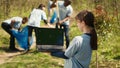 Little child holding a laptop with isolated greenscreen in the woods