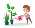 Little child holding a water can in his hands and watering tree with flowers in the pot. Boy or girl taking care about