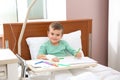 Little child with intravenous drip drawing in hospital Royalty Free Stock Photo