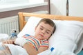 Little child with intravenous drip sleeping in hospital
