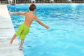 Little child jumping in outdoor swimming pool Royalty Free Stock Photo