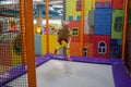 Little child jumping at trampoline in indoors playground. Active toddler girl having fun at sport centre Royalty Free Stock Photo