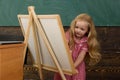 Little child learn drawing on studio easel. I like drawing