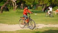 little child learning to cycle in the park