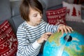 Little child, looking at illuminated globe, exploring Royalty Free Stock Photo