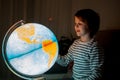 Little child, looking at illuminated globe, exploring Royalty Free Stock Photo