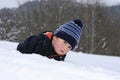 Little child lying on snow