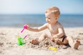 Little child making sand castles at the beach Royalty Free Stock Photo
