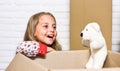 Little child open post package with toys. Deliver your treasures. Storage for toys. Delivering happiness. Delivering