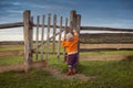 Little child opening  old gates. The storm approaching Royalty Free Stock Photo