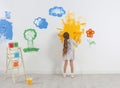 Little child painting wall with roller brush Royalty Free Stock Photo