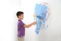 Little child painting wall with roller brush Royalty Free Stock Photo