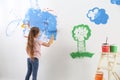 Little child painting wall with roller brush Royalty Free Stock Photo