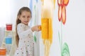 Little child painting wall with roller brush Royalty Free Stock Photo