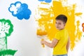 Little child painting wall with roller brush Royalty Free Stock Photo