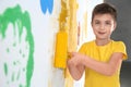 Little child painting wall with roller brush Royalty Free Stock Photo