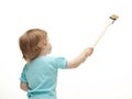 Little child painting white wall Royalty Free Stock Photo