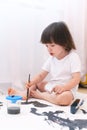 Little child paints with brush and gouache at home Royalty Free Stock Photo
