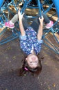 Little child paly on spider web bar in outdoor playground