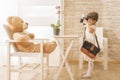 A little child photographer is taking a photo to her teddy bear Royalty Free Stock Photo