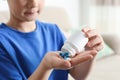 Little child with pills at home, closeup. Danger of medicament