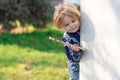 Little child play in park. Outdoor cute little boy playing hide and seek. Adorable child having fun in the park Royalty Free Stock Photo