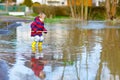 Little child playing with fishing rod by puddle Royalty Free Stock Photo