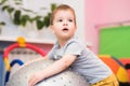 Little baby plays with a fitball in the gym Royalty Free Stock Photo