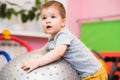 Little baby plays with a fitball in the gym Royalty Free Stock Photo