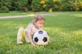 Little child is playing with football ball in park Royalty Free Stock Photo