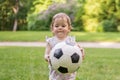 Little child is playing with football ball in park Royalty Free Stock Photo