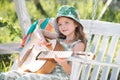 Little child playing guitar. Fashion kid girl. Kids music guitar school. Happy cute teen girl swinging and having fun Royalty Free Stock Photo