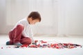 Little child playing with lots of colorful plastic blocks indoor Royalty Free Stock Photo