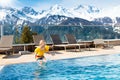 Child in outdoor swimming pool of alpine resort