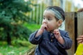 little child playing in the park with fruits, little girl in the autumn park Royalty Free Stock Photo