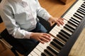 Little child playing piano, above view. Music lesson