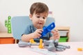 Little child playing with toy construction tools Royalty Free Stock Photo
