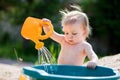 Little child playing with water can Royalty Free Stock Photo