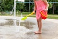Little girl playing at water splash pad fountain in the park playground during hot summer day Royalty Free Stock Photo