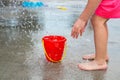 Little girl playing at water splash pad fountain in the park playground during hot summer day Royalty Free Stock Photo