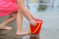 Little girl playing at water splash pad fountain in the park playground during hot summer day Royalty Free Stock Photo