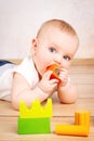 Little child playing with wooden bricks