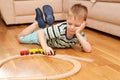 Little child playing with wooden railway