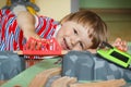 Little child playing with wooden train and tracks. Child development in preschool or nursery concept Royalty Free Stock Photo