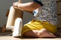 A baby plays with a wooden horse