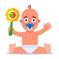 little child plays with a rattle. shake the toy. Royalty Free Stock Photo