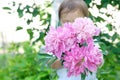 Little child presenting a bouquet of peony flowers Royalty Free Stock Photo