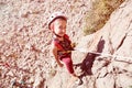 Little Child in protective Helmet climbing Rock Royalty Free Stock Photo