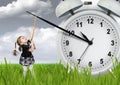 Little child pulling hand clock, time stop concept Royalty Free Stock Photo