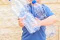 Little child recycling plastic water bottles. World Environment Day.